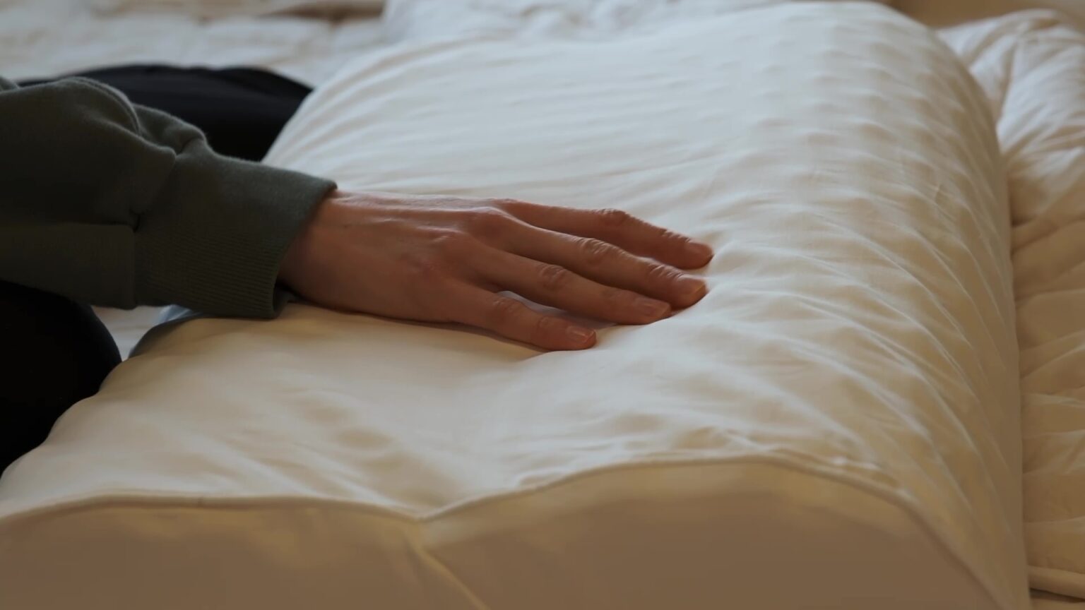 convolute-latex-pillow-model-hand-view_45th-st-bedding
